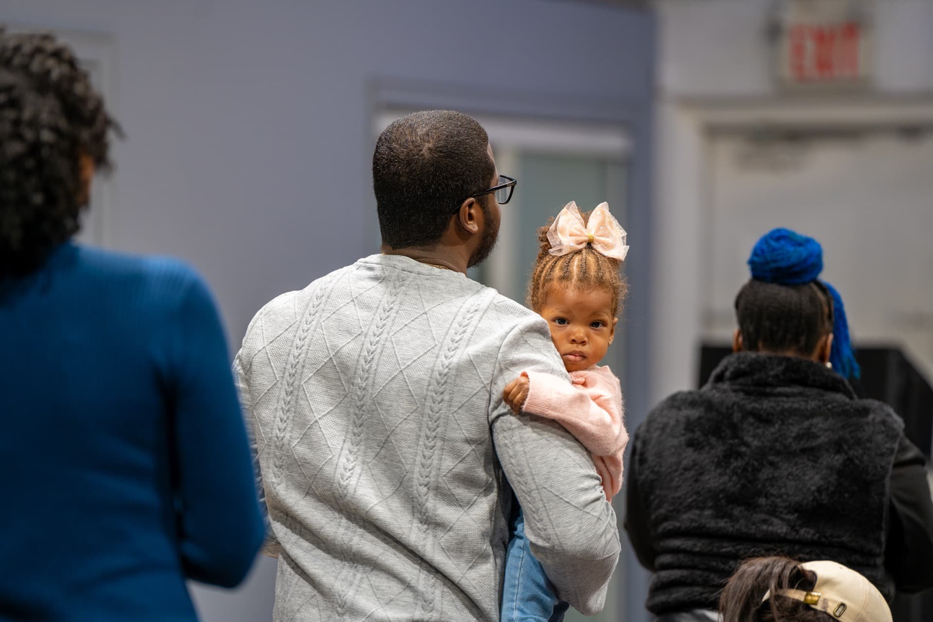 Father holding daughter at KCLC community gathering